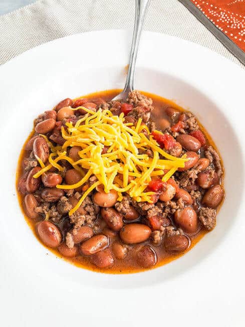 beef and bean chili in a whilte bowl with a natural placemat