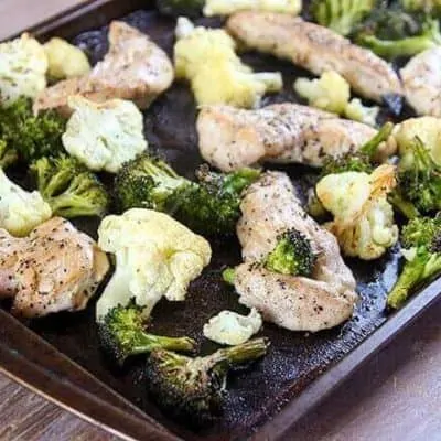 cookie sheet with broccoli, cauliflower, and chicken tenders
