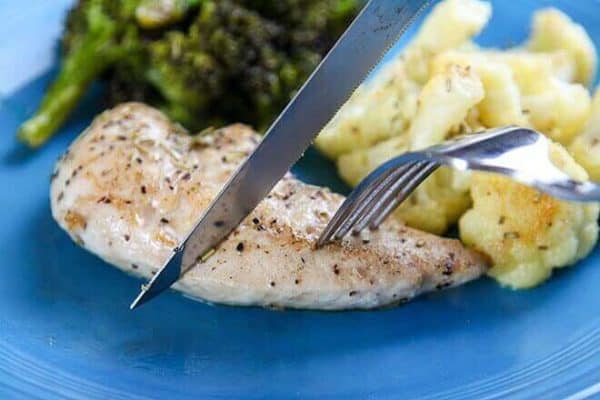 chicken tenders, broccoli, cauliflower, knife & fork