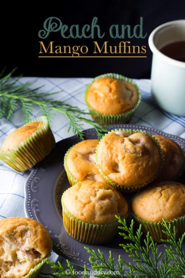Peach and mango muffins on gray plate with greenery