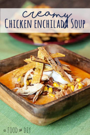 chicken enchilada soup in a wooden bowl on a green placemat