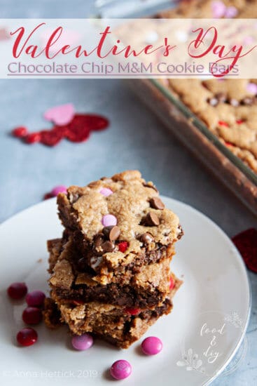 Valentine's day chocolate chip M&M cookie bars in baking pan on gray concrete