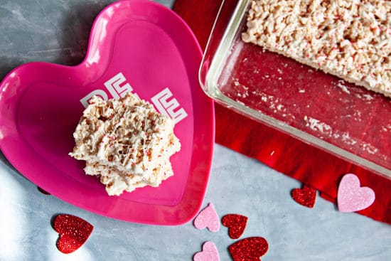 crisp rice cereal treat squares on a pink heart shaped plate